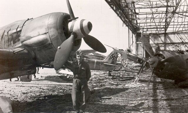 ​ Charles Miller na zničeném letišti v Pardubicích, květen 1945 ​